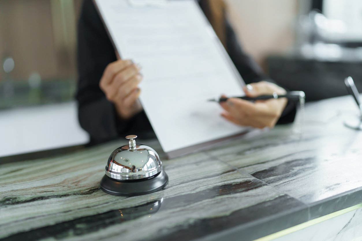 concierge with clipboard and papers