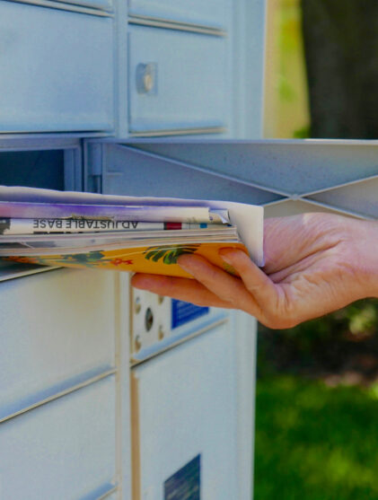 person getting their mail from a shared mailbox