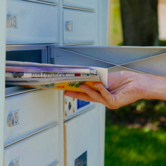 person getting their mail from a shared mailbox