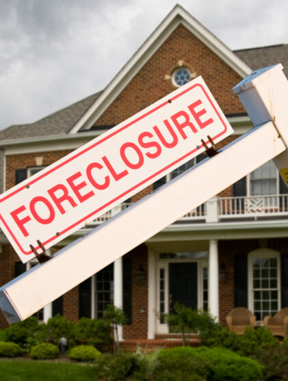 Foreclosure sign in front on modern house
