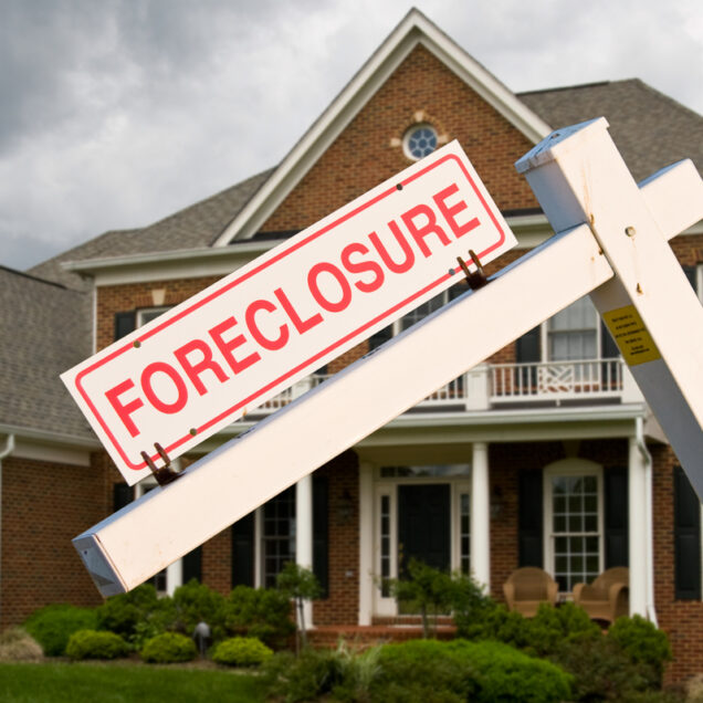 Foreclosure sign in front on modern house