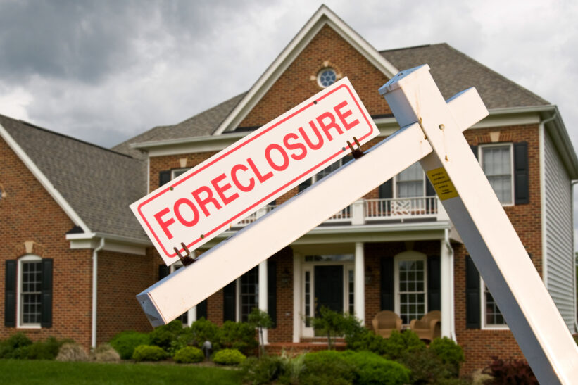 Foreclosure sign in front on modern house