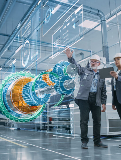 Factory Digitalization: Two Industrial Engineers Use Tablet Computer, Visualize 3D Model of Clean Green Energy Engine. Industry 4 High-Tech Electronics Facility with Machinery Manufacturing Products