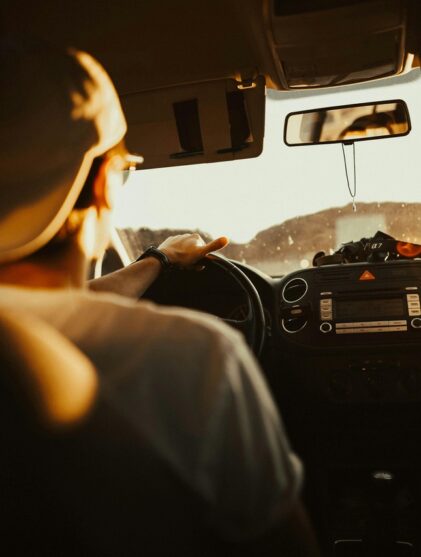 Young man looks out his car windshield