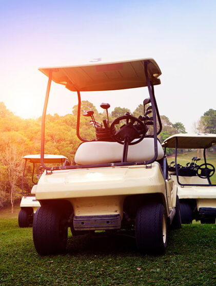 Golf cart on fairway in golf course and beautiful fairway and layout. Tree around fairway on field meadow on mountain.