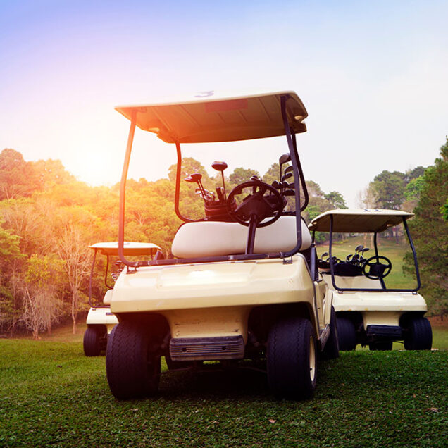 Golf cart on fairway in golf course and beautiful fairway and layout. Tree around fairway on field meadow on mountain.