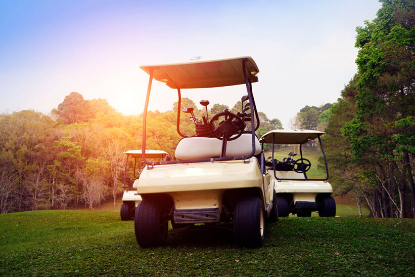 Golf cart on fairway in golf course and beautiful fairway and layout. Tree around fairway on field meadow on mountain.