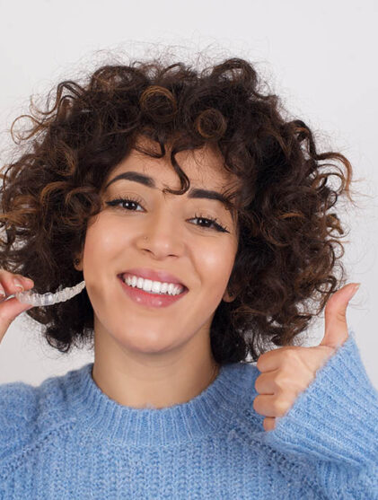 woman smiling with her Invisalign