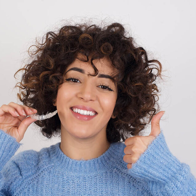 woman smiling with her Invisalign