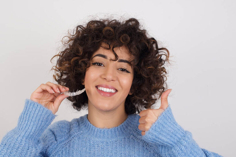 woman smiling with her Invisalign