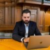 man sitting at laptop
