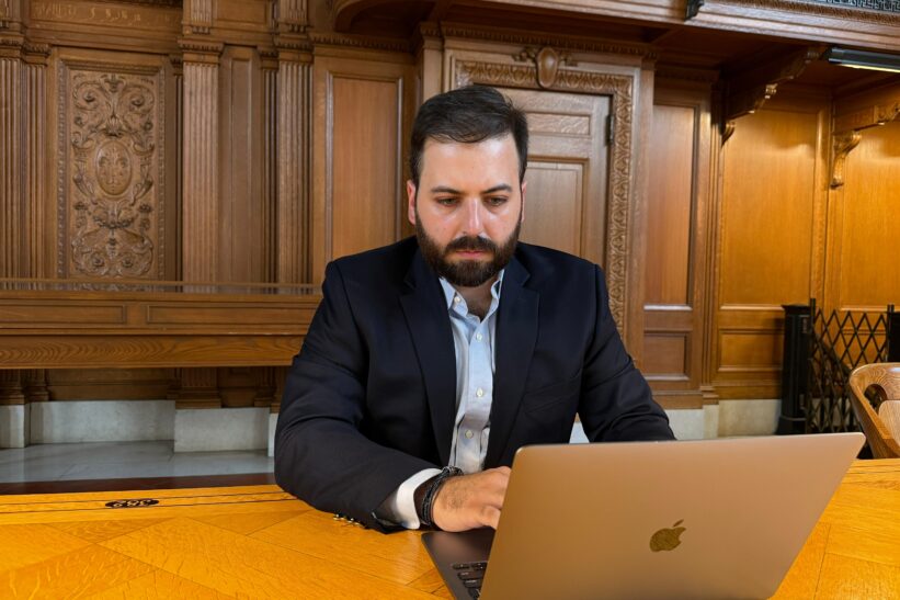 man sitting at laptop