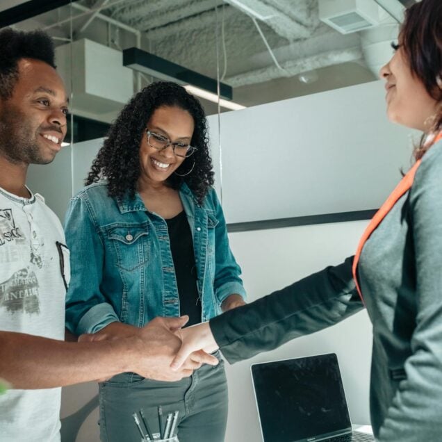 lawyer shaking the hands of clients