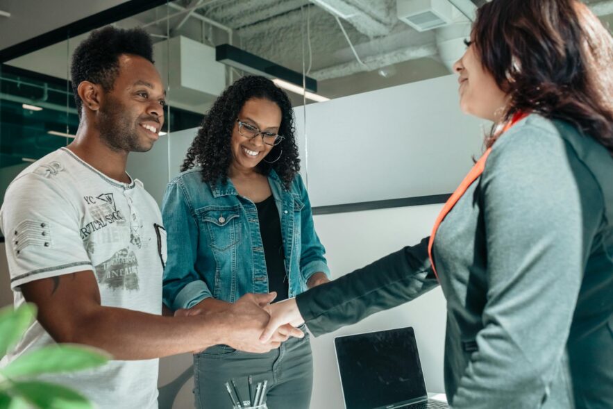 lawyer shaking the hands of clients