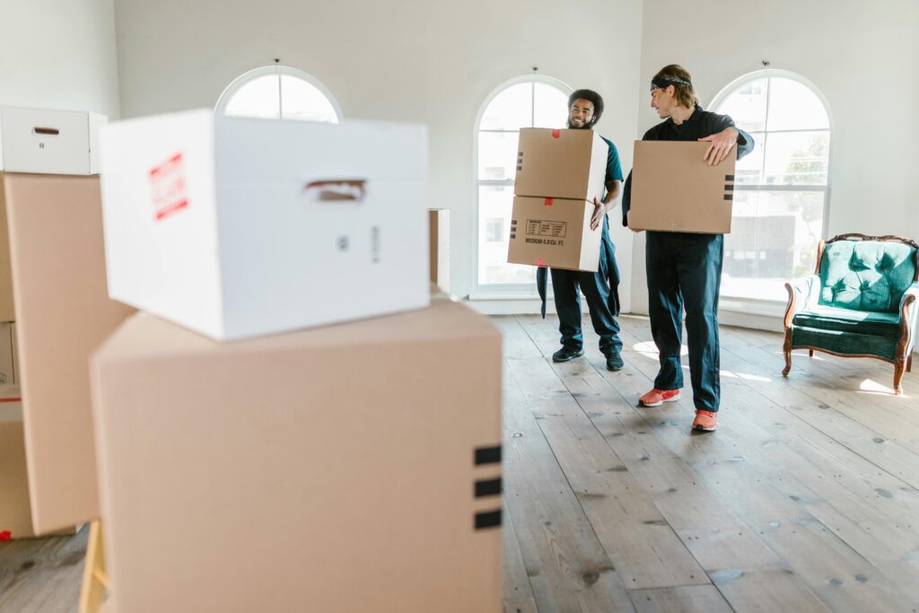 men holding moving boxes