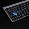 black keyboard with a blue button