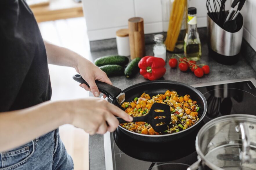 woman cooking in a pan