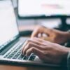 man typing on laptop
