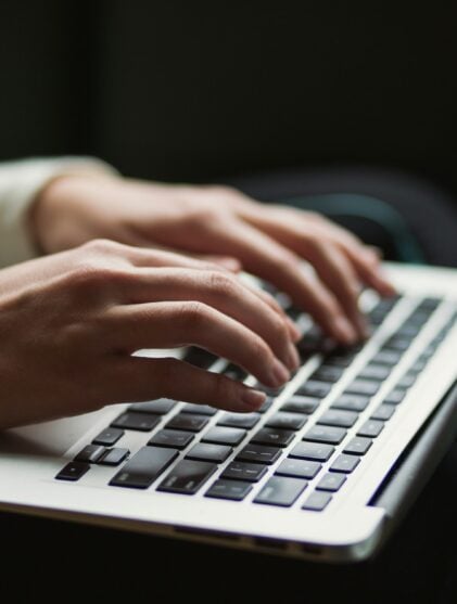 Person typing on laptop