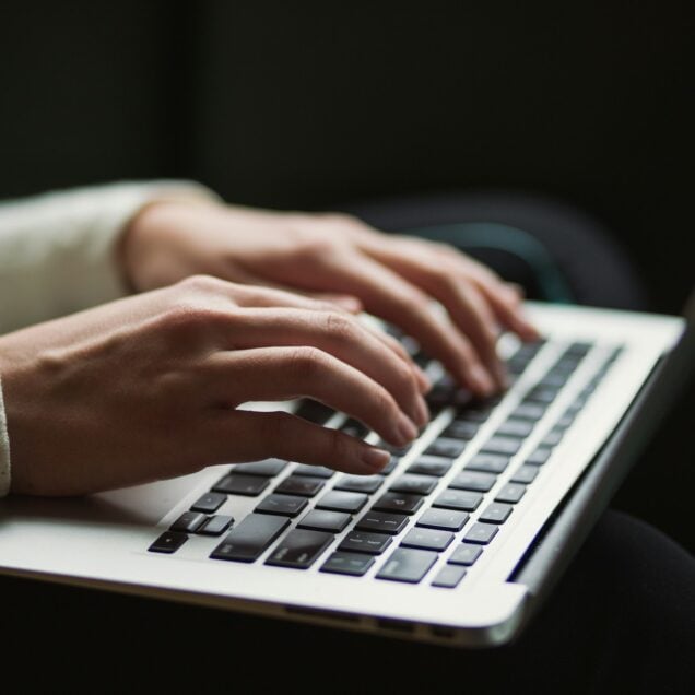 Person typing on laptop