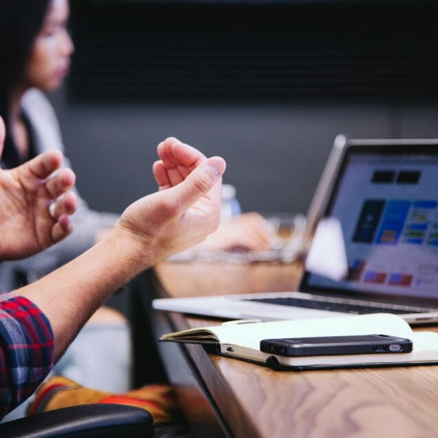 person gesturing during a meeting
