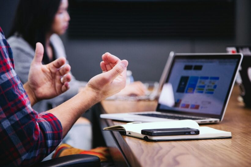 person gesturing during a meeting